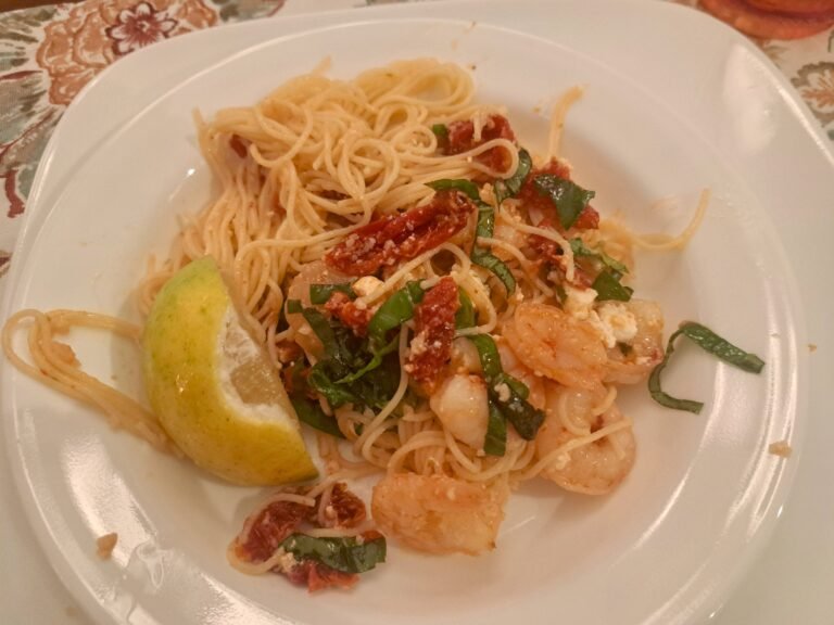 Grilled shrimp over pasta with Feta cheese