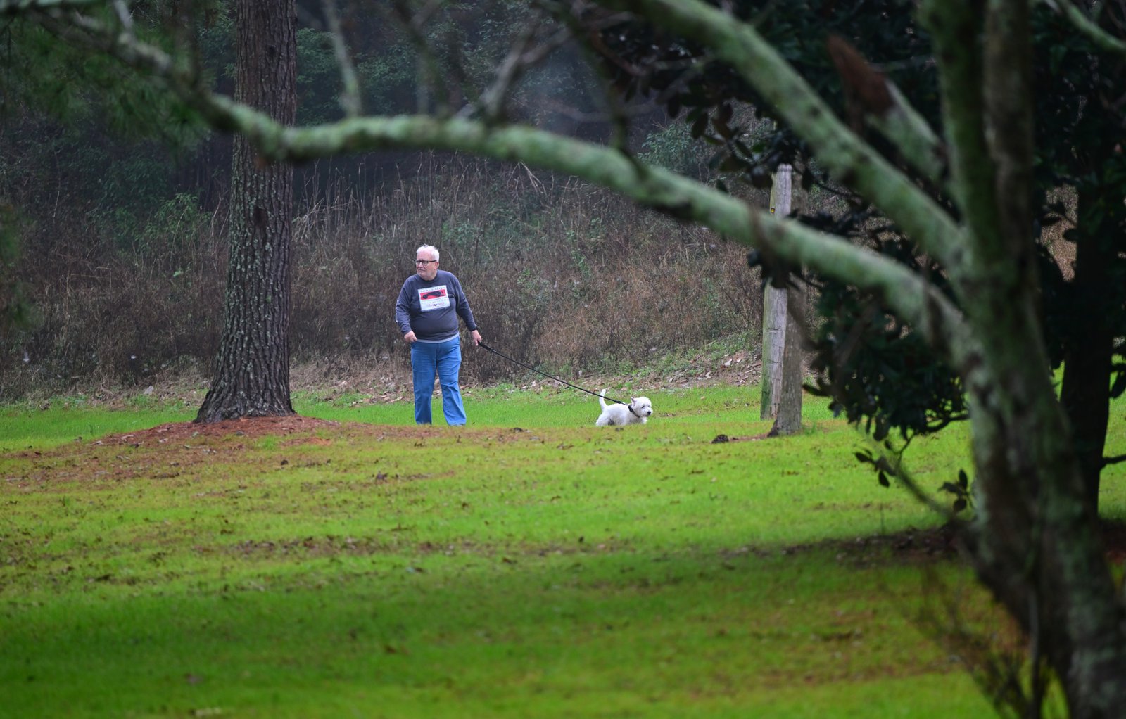 Fairhope resident Felix Bean and Salty walk through North Beach park FEB 07 2025...