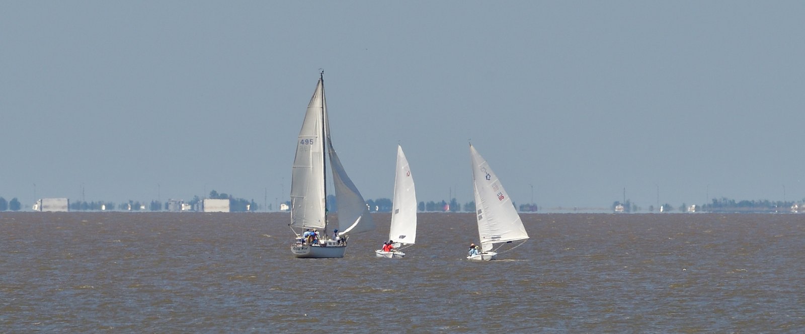 Sailboats take advantage of a light breeze on Mobile Bay