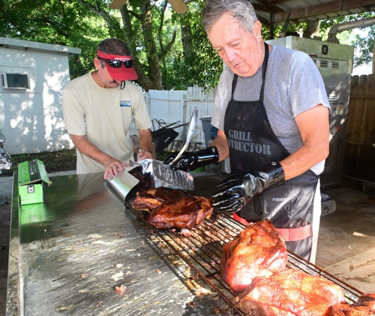 Fairhope Elks Lodge 1879 members prepare pork butts for a fundraiser