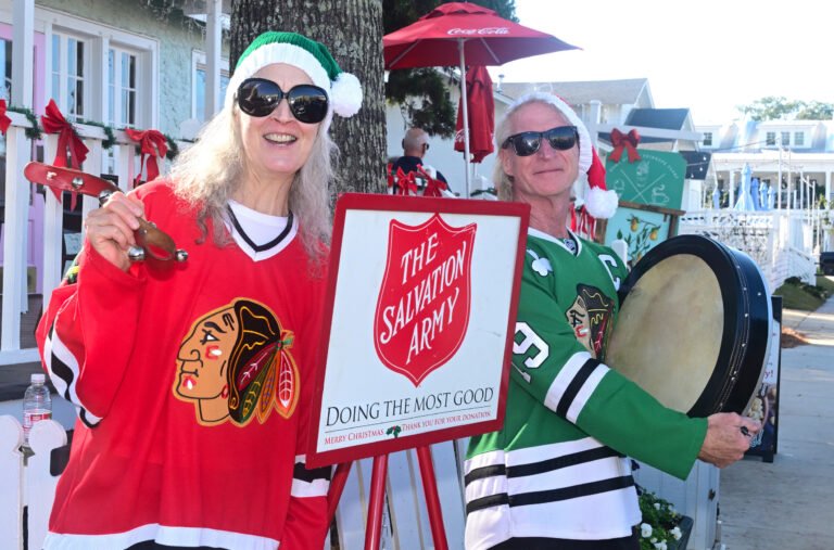 Jefferson and Kelly Moore ring the Salvation Army Christmas bell in Fairhope